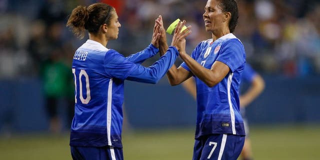 SEATTLE, WA - OCTOBER 21: Shannon Boxx #7 of the United States is congratulated by Carli Lloyd #10 as she is removed from the match in the first half against Brazil at CenturyLink Field on October 21, 2015 in Seattle, Washington. (Photo by Otto Greule Jr/Getty Images)