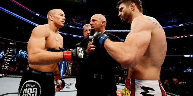 MONTREAL, QC - NOVEMBER 17: Carlos Condit (R) and Georges St-Pierre prepare to fight in their welterweight title bout during UFC 154 on November 17, 2012 at the Bell Centre in Montreal, Canada. (Photo by Josh Hedges/Zuffa LLC/Zuffa LLC via Getty Images)