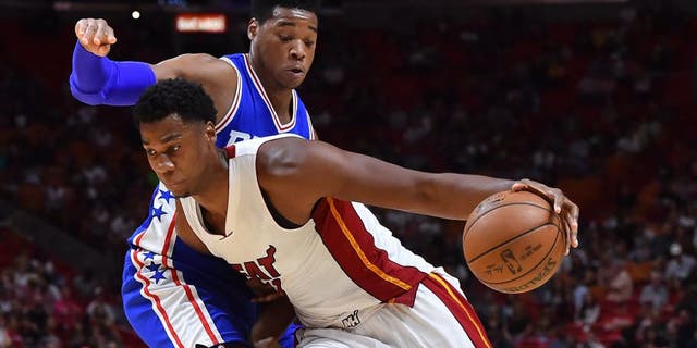 Oct 21, 2016; Miami, FL, USA; Miami Heat center Hassan Whiteside (21) controls the ball around Philadelphia 76ers forward Richaun Holmes (22) during the second half at American Airlines Arena. The Philadelphia 76ers defeat the Miami Heat 113-110. Mandatory Credit: Jasen Vinlove-USA TODAY Sports