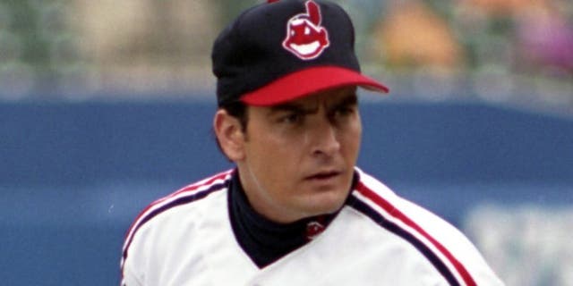 BALTIMORE, MD - SEPTEMBER, 1993: Actor Charlie Sheen as Rick Wild Thing Vaughn #99 of the Cleveland Indians gets the sign for the next pitch from the catcher during the filming of the motion picture "Major League II" in September, 1993 at Camden Yards in Baltimore, Maryland. (Photo by: Diamond Images/Getty Images)