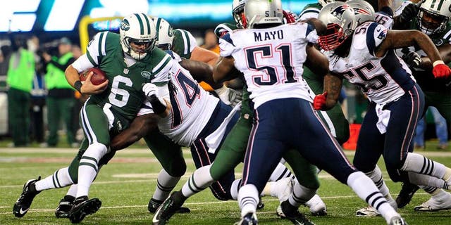 Nov 22, 2012; East Rutherford, NJ, USA; New York Jets quarterback Mark Sanchez (6) runs against the New England Patriots during the second half on Thanksgiving at Metlife Stadium. Mandatory Credit: Joe Camporeale-USA TODAY Sports