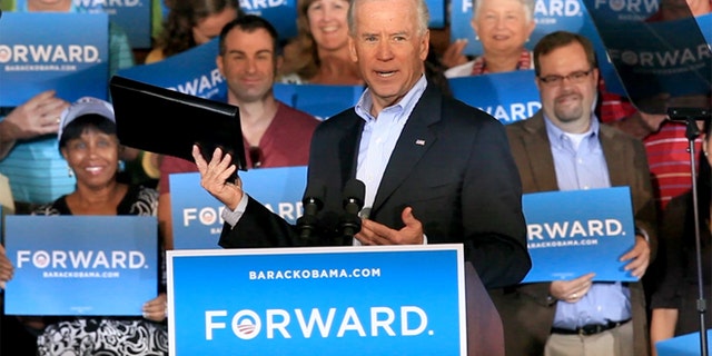 Oct. 20, 2012: Vice President Joe Biden holds up a binder while remarking on Republican presidential candidate Mitt Romney's recent debate gaffe during a visit to Ketterlinus Gymnasium in St. Augustine, Fla.