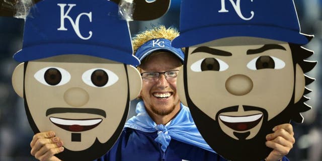 TORONTO, ON - OCTOBER 21: A Kansas City Royals fan holds up signs prior to game five of the American League Championship Series between the Toronto Blue Jays and the Kansas City Royals at Rogers Centre on October 21, 2015 in Toronto, Canada. (Photo by Vaughn Ridley/Getty Images)