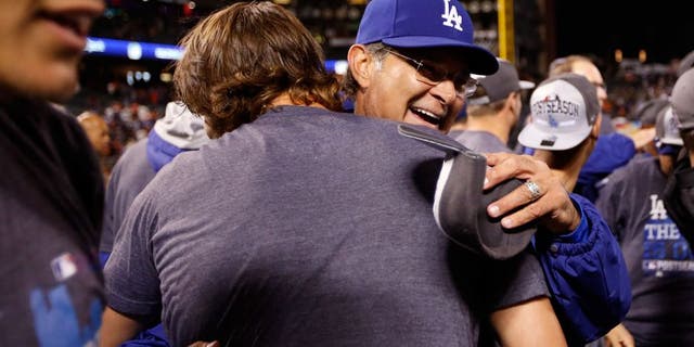 SAN FRANCISCO, CA - SEPTEMBER 29: Manager Don Mattingly hugs Clayton Kershaw #22 of the Los Angeles Dodgers after they beat the San Francisco Giants to clinch the National League West title at AT&T Park on September 29, 2015 in San Francisco, California. (Photo by Ezra Shaw/Getty Images)