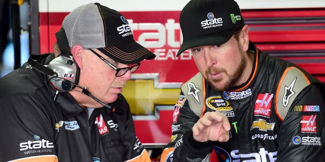 CHARLOTTE, NC - OCTOBER 08: Kurt Busch, driver of the #41 State Water Heaters Chevrolet, talks with his crew chief Tony Gibson in the garage area during practice for the NASCAR Sprint Cup Series Bank of America 500 at Charlotte Motor Speedway on October 8, 2015 in Charlotte, North Carolina. (Photo by Jared C. Tilton/NASCAR via Getty Images)