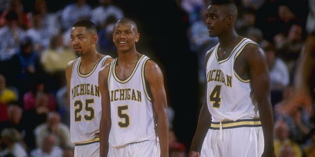 8 Mar 1992: Michigan Wolverines forward Juwan Howard, guard Jalen Rose, and forward Chris Webber (l to r) look on during a game against the Indiana Pacers.