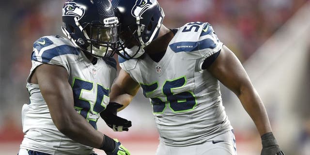 SANTA CLARA, CA - OCTOBER 22: Frank Clark #55 and Cliff Avril #56 of the Seattle Seahawks react after a sack on Colin Kaepernick #7 of the San Francisco 49ers during their NFL game at Levi's Stadium on October 22, 2015 in Santa Clara, California. (Photo by Thearon W. Henderson/Getty Images)