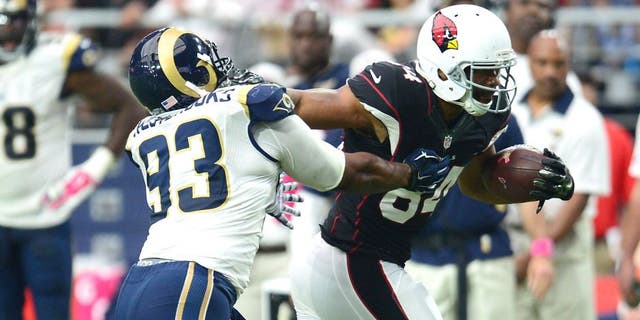 Oct 4, 2015; Glendale, AZ, USA; Arizona Cardinals tight end Jermaine Gresham (84) stiff arms St. Louis Rams defensive tackle Ethan Westbrooks (93) during the second half at University of Phoenix Stadium. The Rams won 24-22. Mandatory Credit: Joe Camporeale-USA TODAY Sports