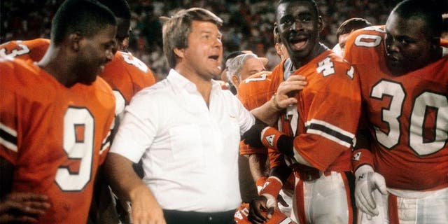 MIAMI, FL - JANUARY 1: Head coach Jimmy Johnson of the #2 rank University of Miami Hurricanes football team with his arm on wide receiver Michael Irvin #47 January 1, 1988 after the NCAA Orange Bowl football Game against the #1 rank Oklahoma University Sooner at the Orange Bowl in Miami, Florida. The Hurricanes won the game 20-14 and became the National Champions. Johnson was the head coach of the Miami Hurricanes from 1984-88. (Photo by Focus on Sport/Getty Images)