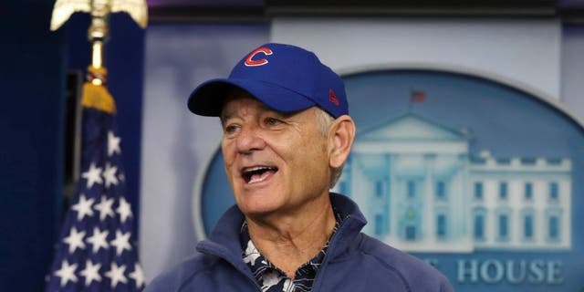 Actor Bill Murray wears a Chicago Cubs jacket and hoodie during a brief visit in the Brady press briefing room of the White House in Washington, Friday, Oct. 21, 2016.