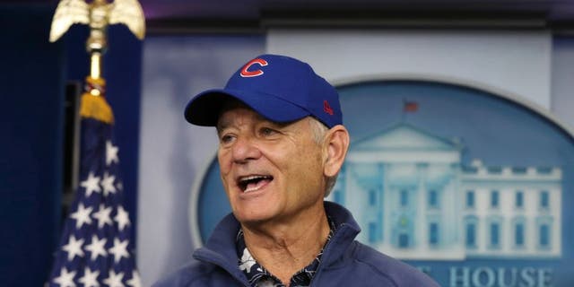 Actor Bill Murray sporting a Chicago Cubs jacket and cap talks during a brief visit in the Brady Press Briefing Room of the White House in Washington, Friday, Oct. 21, 2016.