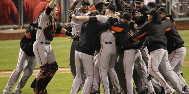 Oct. 23: The San Francisco Giants celebrate after the ninth inning of Game 6 of baseball's National League Championship Series against the Philadelphia Phillies in Philadelphia.