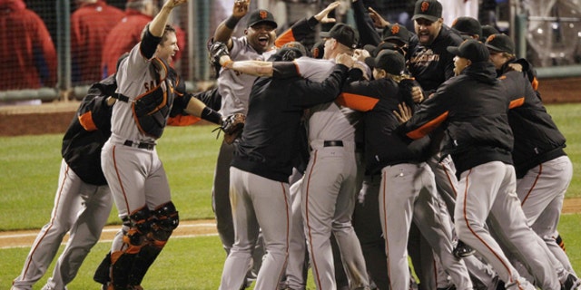 Oct. 23: The San Francisco Giants celebrate after the ninth inning of Game 6 of baseball's National League Championship Series against the Philadelphia Phillies in Philadelphia.