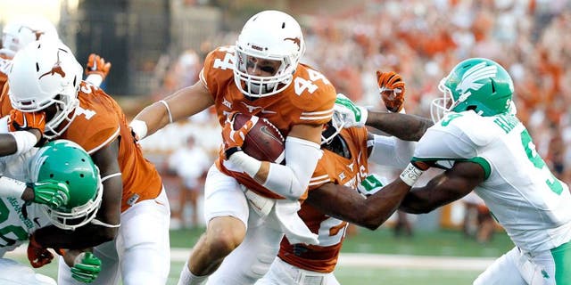 Aug 30, 2014; Austin, TX, USA; Texas Longhorns defensive back Dylan Haines (44) run with the ball after an interception against the North Texas Mean Green during the first half at Darrell K Royal-Texas Memorial Stadium. Mandatory Credit: Soobum Im-USA TODAY Sports