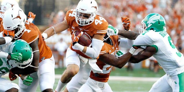 Aug 30, 2014; Austin, TX, USA; Texas Longhorns defensive back Dylan Haines (44) run with the ball after an interception against the North Texas Mean Green during the first half at Darrell K Royal-Texas Memorial Stadium. Mandatory Credit: Soobum Im-USA TODAY Sports