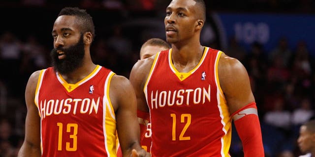 Mar 5, 2014; Orlando, FL, USA; Houston Rockets shooting guard James Harden (13) and Houston Rockets center Dwight Howard (12) against the Orlando Magic during the second half at Amway Center. Houston Rockets defeated the Orlando Magic 101-89. Mandatory Credit: Kim Klement-USA TODAY Sports