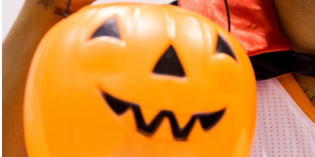 Sep 30, 2013; Phoenix, AZ, USA; Phoenix Suns forward Markieff Morris poses for a portrait wearing Dracula fangs and cape while holding a Halloween pumpkin during media day at US Airways Center. Mandatory Credit: Mark J. Rebilas-USA TODAY Sports