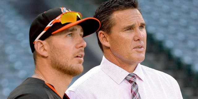 ANAHEIM, CA - AUGUST 26: Jeff Mathis #6 of the Miami Marlins talks to assistant general manager Scott Servais of the Los Angeles Angels of Anaheim before the game on August 26, 2014 at Angel Stadium of Anaheim in Anaheim, California. (Photo by Matt Brown/Angels Baseball LP/Getty Images)