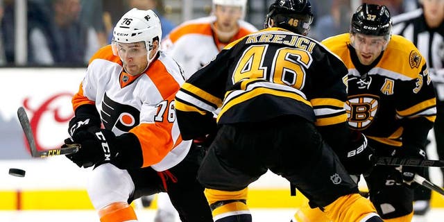 Oct 21, 2015; Boston, MA, USA; Philadelphia Flyers center Chris VandeVelde (76) tries to get past Boston Bruins center David Krejci (46) during the second period of the Philadelphia Flyers 5-4 overtime win over the Boston Bruins at TD Garden. Mandatory Credit: Winslow Townson-USA TODAY Sports