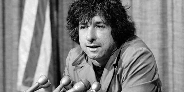 FILE - In this Dec. 6, 1973 file photo, political activist Tom Hayden, husband of Jane Fonda, tells newsmen in Los Angeles that he believes public support was partially responsible for the decision not to send him and others of the Chicago 7 to jail for contempt.