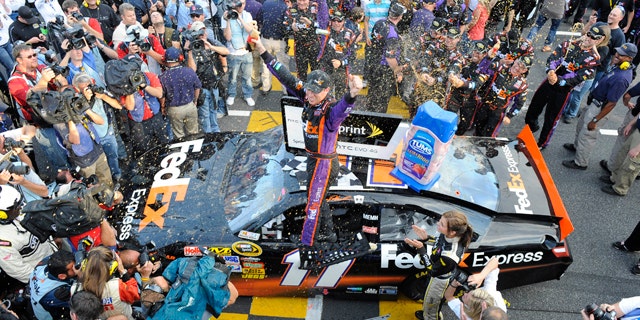 Oct. 24: Denny Hamlin celebrates after winning the NASCAR Sprint Cup Series auto race at Martinsville Speedway in Martinsville, Va.