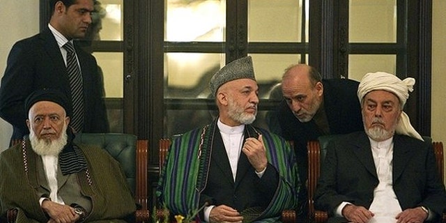Oct. 7: Afghan President Hamid Karzai speaks to his staff during the inauguration ceremony for the High Peace Council, appointed to broker peace with the insurgents in Afghanistan, at the presidential palace in Kabul.