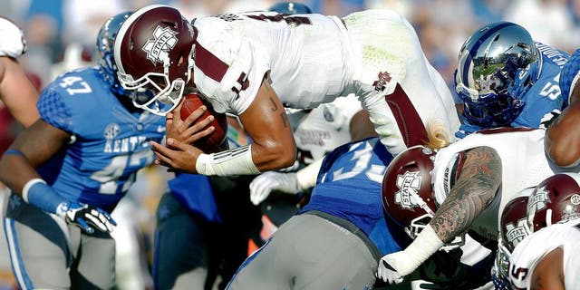 Oct 25, 2014; Lexington, KY, USA; Mississippi State Bulldogs quarterback Dak Prescott (15) dives for a touchdown against the Kentucky Wildcats in the first half at Commonwealth Stadium. Mandatory Credit: Mark Zerof-USA TODAY Sports