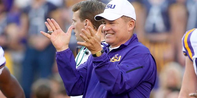 Oct 25, 2014; Baton Rouge, LA, USA; LSU Tigers head coach Les Miles claps for his team during pre game warm ups on the field prior to kickoff against the Mississippi Rebels at Tiger Stadium. LSU defeated Mississippi 10-7. Mandatory Credit: Crystal LoGiudice-USA TODAY Sports
