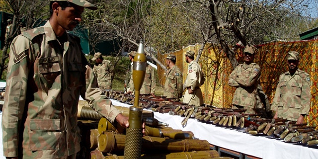 Oct. 26: Pakistan army soldiers stand near confiscated arms and ammunition during operations against militants in Kalaya in Pakistan's tribal area of Orakzai near the Afghanistan border.
