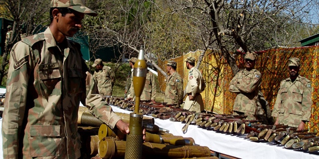 Oct. 26: Pakistan army soldiers stand near confiscated arms and ammunition during operations against militants in Kalaya in Pakistan's tribal area of Orakzai near the Afghanistan border.
