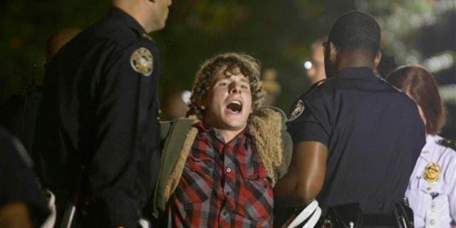 October 26, 2011: A protestor of the Occupy Atlanta demonstration is arrested after refusing to leave their camp after Mayor Kasim Reed revoked his executive order allowing the protestors to camp out in Woodruff Park.