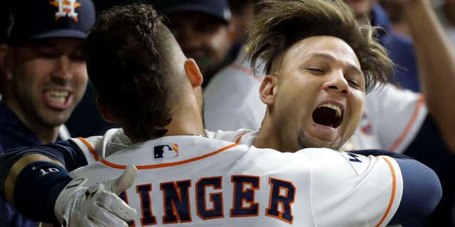 Houston Astros' Yuli Gurriel is congratulated by George Springer after hitting a home run during the second inning of Game 3 of baseball's World Series against the Los Angeles Dodgers, Oct. 27, 2017, in Houston.