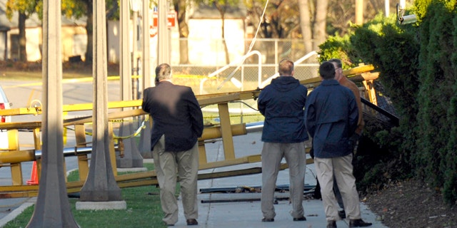 Oct. 27: Notre Dame personnel examine a location where a tower used to video Notre Dame football practice blew over in South Bend, Ind.