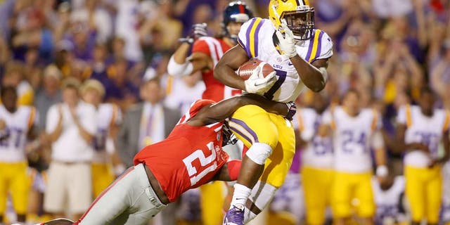 Oct 25, 2014; Baton Rouge, LA, USA; LSU Tigers running back Leonard Fournette (7) is tackled by Mississippi Rebels defensive back Senquez Golson (21) as he carries the ball in the first quarter at Tiger Stadium. Mandatory Credit: Crystal LoGiudice-USA TODAY Sports