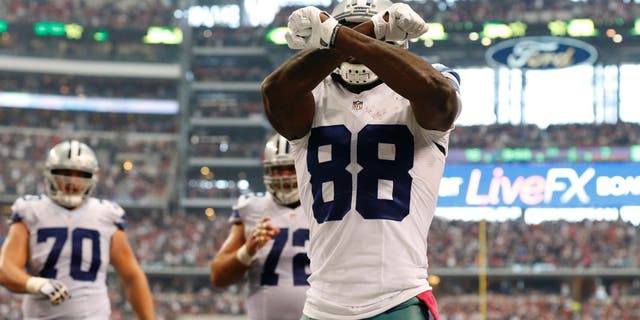 Oct 5, 2014; Arlington, TX, USA; Dallas Cowboys receiver Dez Bryant (88) celebrates his fourth quarter touchdown against the Houston Texans at AT&T Stadium. Mandatory Credit: Matthew Emmons-USA TODAY Sports