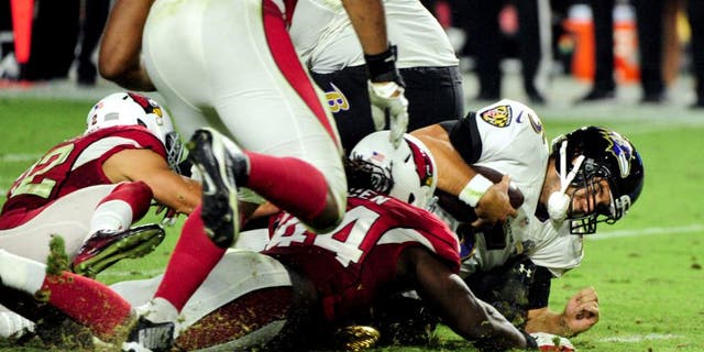 Oct 26, 2015; Glendale, AZ, USA; Baltimore Ravens quarterback Joe Flacco (5) is sacked by Arizona Cardinals free safety Tyrann Mathieu (32) during the second half at University of Phoenix Stadium. Mandatory Credit: Matt Kartozian-USA TODAY Sports