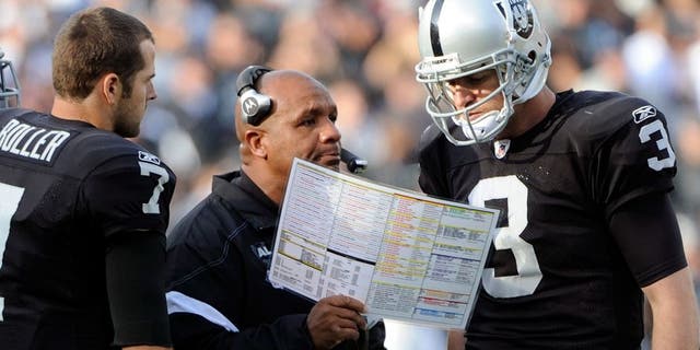 OAKLAND, CA - NOVEMBER 27: Head Coach Hue Jackson and quarterback Carson Palmer #3 of the Oakland Raiders looks over the game plan against the Chicago Bears at O.co Coliseum on November 27, 2011 in Oakland, California. The Raiders won the game 25-20. (Photo by Thearon W. Henderson/Getty Images) *** Local Caption *** Hue Jackson; Carson Palmer