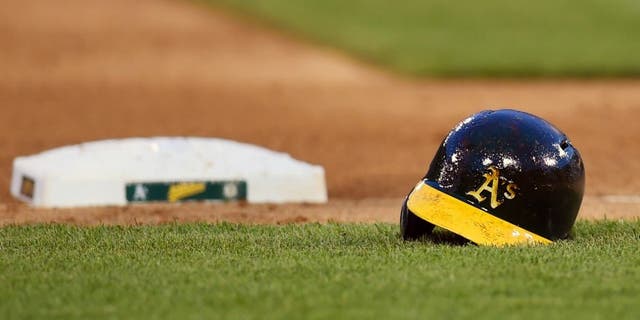 OAKLAND, CA - MAY 10: The batting helmet belonging to Josh Reddick #16 of the Oakland Athletics sets on the field during a Major League Baseball game against the Washington Nationals at O.co Coliseum on May 10, 2014 in Oakland, California. (Photo by Thearon W. Henderson/Getty Images)