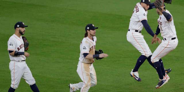 Houston Astros' Carlos Correa and George Springer celebrate after Game 3 of baseball's World Series against the Los Angeles Dodgers Friday, Oct. 27, 2017, in Houston.