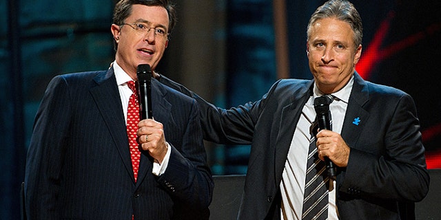 In this Oct. 2, 2010 file photo, Stephen Colbert, left, and Jon Stewart appear on stage at Comedy Central's 'Night Of Too Many Stars: An Overbooked Concert For Autism Education' at the Beacon Theatre in New York.