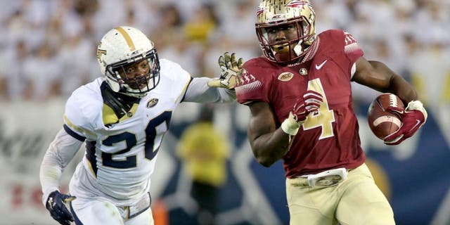 Oct 24, 2015; Atlanta, GA, USA; Florida State Seminoles running back Dalvin Cook (4) runs against Georgia Tech Yellow Jackets defensive back Lawrence Austin (20) in the second quarter of their game at Bobby Dodd Stadium. Mandatory Credit: Jason Getz-USA TODAY Sports