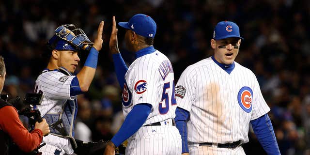 Cubs teammates, from left, Willson Contreras, Aroldis Chapman and Anthony Rizzo celebrate after Game 5 of the World Series against the Cleveland Indians on Oct. 30, 2016, in Chicago.