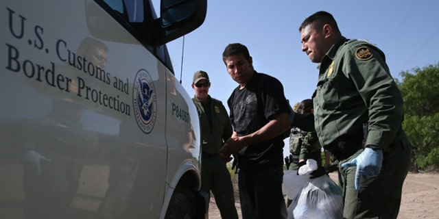 MISSION, TX - APRIL 11:  U.S. Border Patrol agents detain undocumented immigrants near the U.S.-Mexico border on April 11, 2013 near Mission, Texas. A group of 16 immigrants from Mexico and El Salvador said they crossed the Rio Grande River from Mexico into Texas during the morning hours before they were caught. The Rio Grande Valley sector of has seen more than a 50 percent increase in illegal immigrant crossings from last year, according to the Border Patrol. Agents say they have also seen an additional surge in immigrant traffic since immigration reform negotiations began this year in Washington D.C. Proposed refoms could provide a path to citizenship for many of the estimated 11 million undocumented workers living in the United States. Photo by John Moore/Getty Images)  (Photo by John Moore/Getty Images)