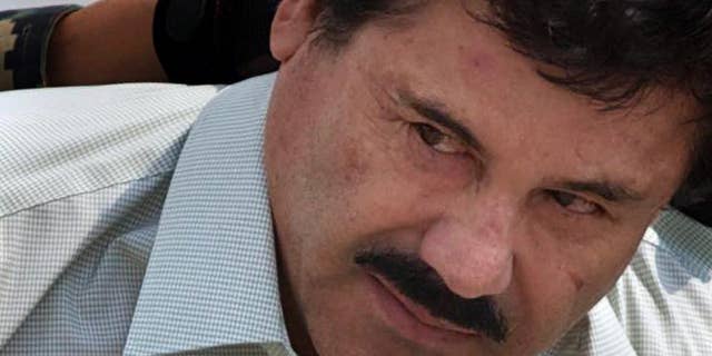 FILE - In this Feb. 22, 2014, file photo, Joaquin "El Chapo" Guzman is escorted to a helicopter by Mexican navy marines in Mexico City, Mexico. The normally bucolic, vacationer-laden Mexican state at the tip of Baja peninsula is now the scene of dozens of killings in what authorities call a power struggle resulting from the February arrest of international drug lord Joaquin “El Chapo” Guzman. (AP Photo/Eduardo Verdugo, File)