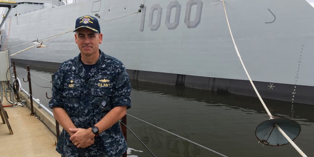 Capt. James Kirk, skipper of the future USS Zumwalt, standing in front of the destroyer on Tuesday.