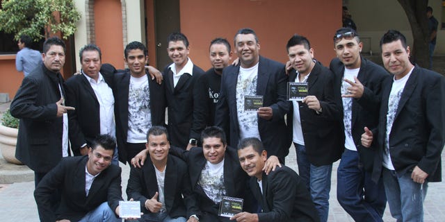 In this Nov. 15, 2011 photo, members of the Colombian style music band Kombo Kolombia pose for the press during a promotional event in Monterrey, Mexico. Sixteen members of the band Kombo Kolombia and four crew members were kidnapped on Friday, Jan. 25, 2013, after playing at a private party held at a ranch called La Carreta, or The Wagon, in the town of Hidalgo north of Monterrey. A member of the band, who managed to escape, led authorities to a well along a dirt road where searchers found several bodies which, authorities said on Monday, Jan. 28, all indicates that they belong to the missing band members. (AP Photo)