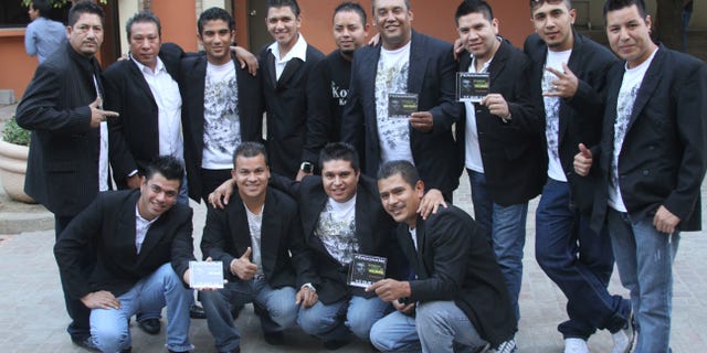 In this Nov. 15, 2011 photo, members of the Colombian style music band Kombo Kolombia pose for the press during a promotional event in Monterrey, Mexico. Sixteen members of the band Kombo Kolombia and four crew members were kidnapped on Friday, Jan. 25, 2013, after playing at a private party held at a ranch called La Carreta, or The Wagon, in the town of Hidalgo north of Monterrey. A member of the band, who managed to escape, led authorities to a well along a dirt road where searchers found several bodies which, authorities said on Monday, Jan. 28, all indicates that they belong to the missing band members. (AP Photo)
