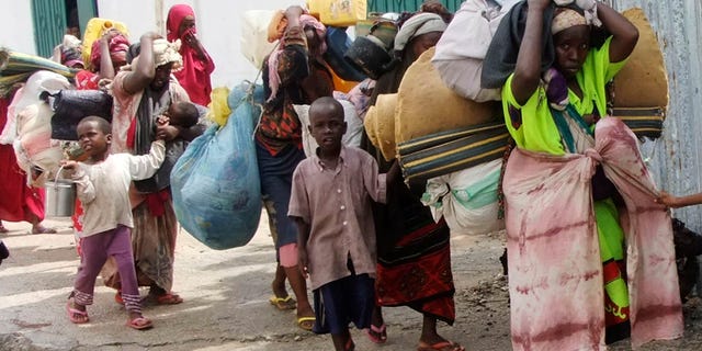 Aug. 5, 2011: Somalis carry their belongings from southern Somalia as they arrive in Mogadishu, Somalia