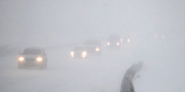 Vehicles commute southbound on the Garden State Parkway in whiteout conditions during a snowstorm, Thursday, Jan. 4, 2018, in Eatontown, N.J.