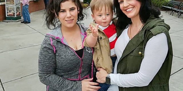 Samantha Snipes (left), Vaughn and Temple Phipps (right) pose for a picture.